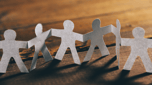 Paper cutout figures holding hands